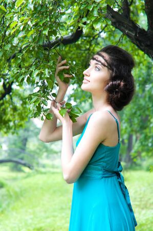 Portrait of the beautiful woman in the green gardenの写真素材