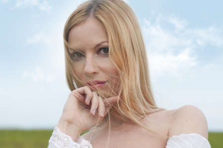 Portrait of the beautiful woman with sky backgroundの写真素材