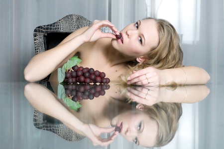 Luxury Portrait of the beautiful blonde with grape  の写真素材