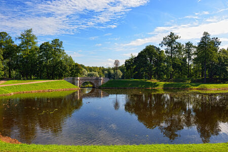 Summer landscape with lake and bridge in Gatchina park, Russiaの写真素材