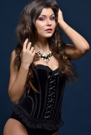 Beautifu woman in black lingerie posing in studio.の写真素材