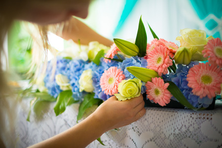Florist making flower decoration on tableの写真素材