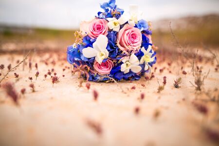 wedding bouquet on the ground at sunsetの写真素材