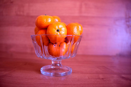 tangerines in a vase on a tableの写真素材