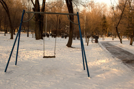 funny doll swinging on a swingの写真素材