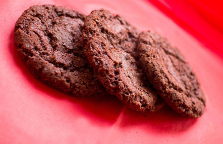chocolate chip cookies on a red backgroundの写真素材