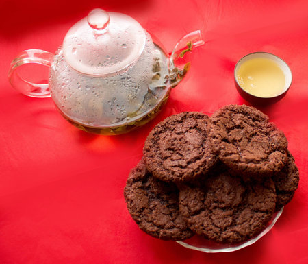 still life, transparent glass teapot, cup with tea, cookies