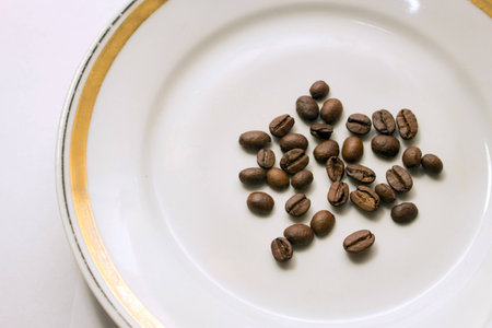 coffee beans on a white saucerの写真素材