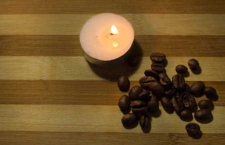 coffee beans and a lighted candle