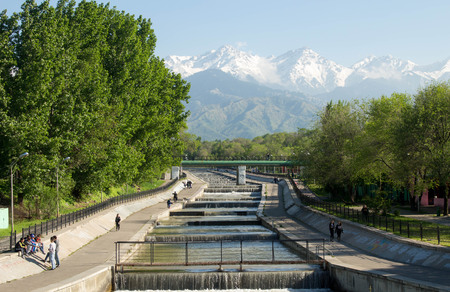 Almaty, Kazakhstan - 05.07.2018: Al-Farabi avenue. people in the first president's park of Almaty. Early spring time, people walk.のeditorial素材
