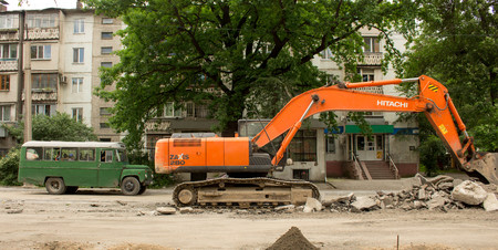 excavator excavates asphalt