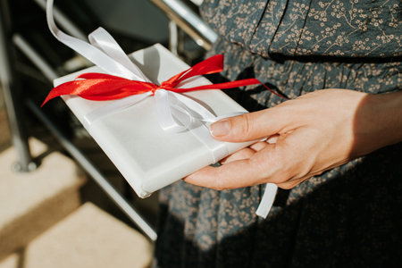 Woman hold gift in hand. Holiday present. Box with surprise. Happy celebration event. Kraft paper...