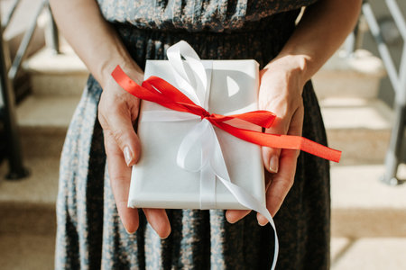 Woman hold gift in hand. Holiday present. Box with surprise. Happy celebration event. Kraft paper...