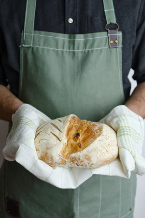 Crispy fresh bread in the hands of a man. Rustic organic wheat bread. Gluten free. Home baking bread...