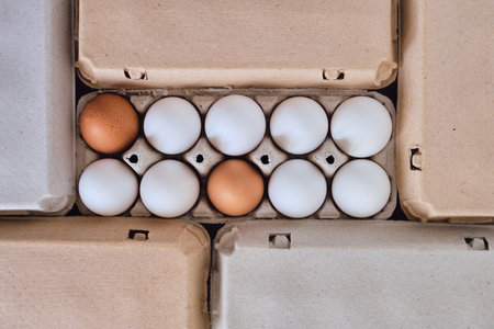 Cardboard boxes with chicken eggs. Boxes with uncooked eggs in table. Natural organic farm product....