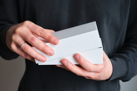 Man holding in hand small paper box. Blank packing, empty space. Male with a new package. Postal...