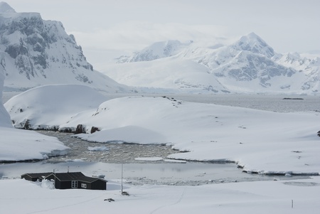 The Antarctic winter station on the background of mountains and ocean.の写真素材