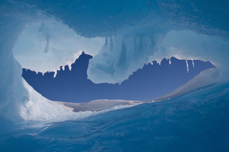 hole in an iceberg with a view of the Antarctic winter sky