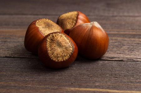 Several hazelnuts on a wooden backgroundの写真素材
