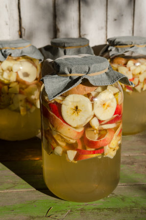 Making of apple vinegar - apple pieces floating on water in a glass