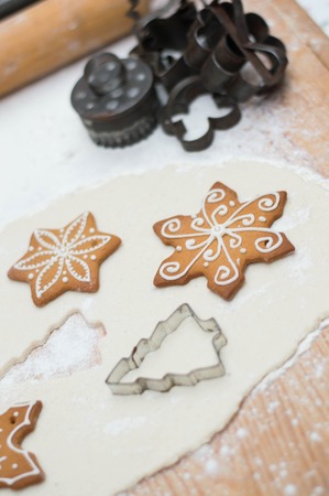 Old gingerbread maker baking sheet on wooden table with antiquitiesの写真素材