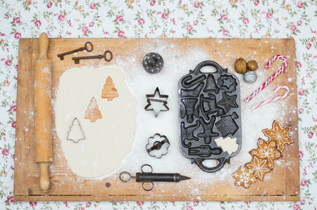 Old gingerbread maker baking sheet on wooden table with antiquitiesの写真素材
