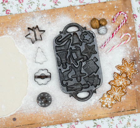 Old gingerbread maker baking sheet on wooden table with antiquitiesの写真素材