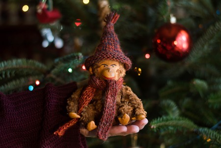 Vintage stuffed monkey toy under the christmas treeの写真素材