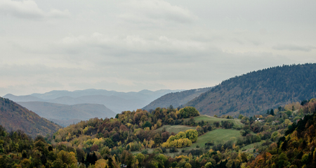 Little traditional peasant cabin in the mountains Europe, Slovakia surrounded with autumn color forest and meadowの写真素材