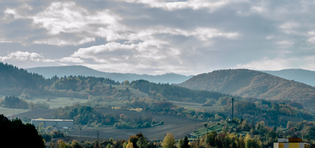 Stunning mountain view from Slovakia - forest and farm in the autumn around morning time, in the first sunshine, little foggy viewの写真素材