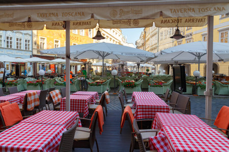 Prague, Czech Republic - October 6, 2014: Street cafe in the square in Prague. Facades of old buildings decorated with stucco.のeditorial素材