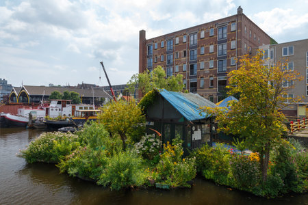 Amsterdam, Netherlands - July 31, 2014: Traditional house boat on the canals of Amsterdam. In Amsterdam, there are about 2,500 homes on the water.のeditorial素材