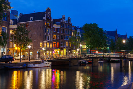 Amsterdam, Netherlands - July 31, 2014: View of the embankment and canal of Amsterdam at night.のeditorial素材