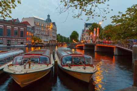 Amsterdam, Netherlands - July 31, 2014: View of the embankment and canal of Amsterdam at night.のeditorial素材