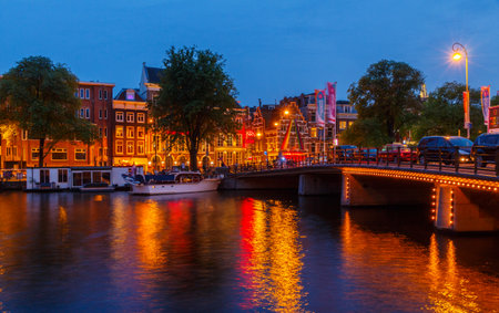 Amsterdam, Netherlands - July 31, 2014: View of the embankment and canal of Amsterdam at night.のeditorial素材