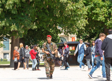 Paris, France - May 3, 2014: A patrol of soldiers in the yard the Louvre. France adopted stringent measures to combat crime and terrorism.のeditorial素材