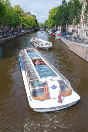 Amsterdam, Netherlands - July 30, 2014: Canals of Amsterdam. Favorite place for walking and leisure travelers.のeditorial素材