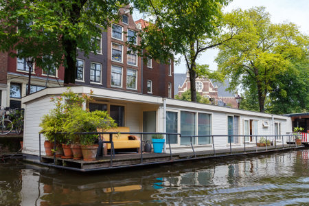 Amsterdam, Netherlands - July 29, 2014: Traditional house boat on the canals of Amsterdam. In Amsterdam, there are about 2,500 homes on the water.のeditorial素材