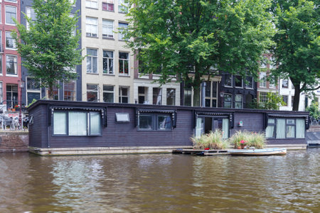 Amsterdam, Netherlands - July 29, 2014: Traditional house boat on the canals of Amsterdam. In Amsterdam, there are about 2,500 homes on the water.のeditorial素材