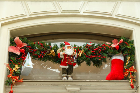 Bruges, Belgium - December 26, 2014: Christmas garland with Santa on the window.のeditorial素材