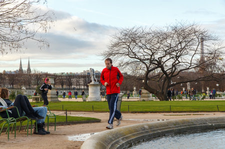 Paris, France - December 20, 2014: People go running outdoors in the garden of the Tuileries.のeditorial素材