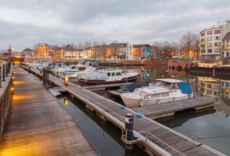 Boat harbor on the river Leie in Ghent at sunset.