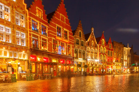 Bruges, Belgium - December 23, 2014: Central Bruges Market Square at sunset decorated at Christmas.のeditorial素材