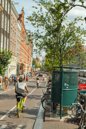 Amsterdam, Netherlands - August 3, 2014: People moving to Amsterdam on bicycles. Most popular transport in the Netherlands.のeditorial素材