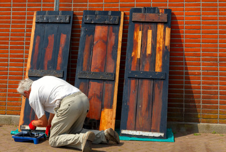 Amsterdam, Netherlands - July 31, 2014: Employee Amsterdam museum Nemo stain the wooden parts of ships exposure.のeditorial素材