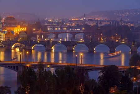The view from the heights of Prague Vltava River and bridges at night. Night lighting and illumination of bridges and embankment in Prague.の写真素材