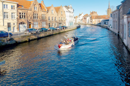 Bruges Belgium December 28 2014: Excursion tour by boat on the canal Spiegel Rei of the medieval city of Bruges Belgium.のeditorial素材