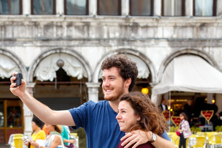 Venice Italy May 20 2015: Tourists are photographed on St. Mark39s Square with pigeons. Pigeons fly in the area for the food from the tourists.のeditorial素材