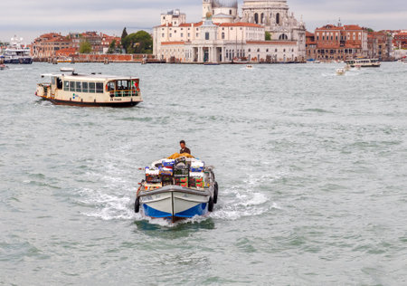 Venice Italy May 21 2015: Cargo Venetian motor barge. All products and goods delivered to Venice by sea and canals in the city.のeditorial素材
