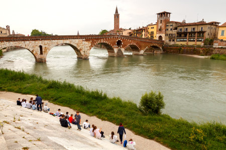 Verona Italy May 26 2015: Children on the waterfront Verona paint a bridge over the River Adige from nature.のeditorial素材